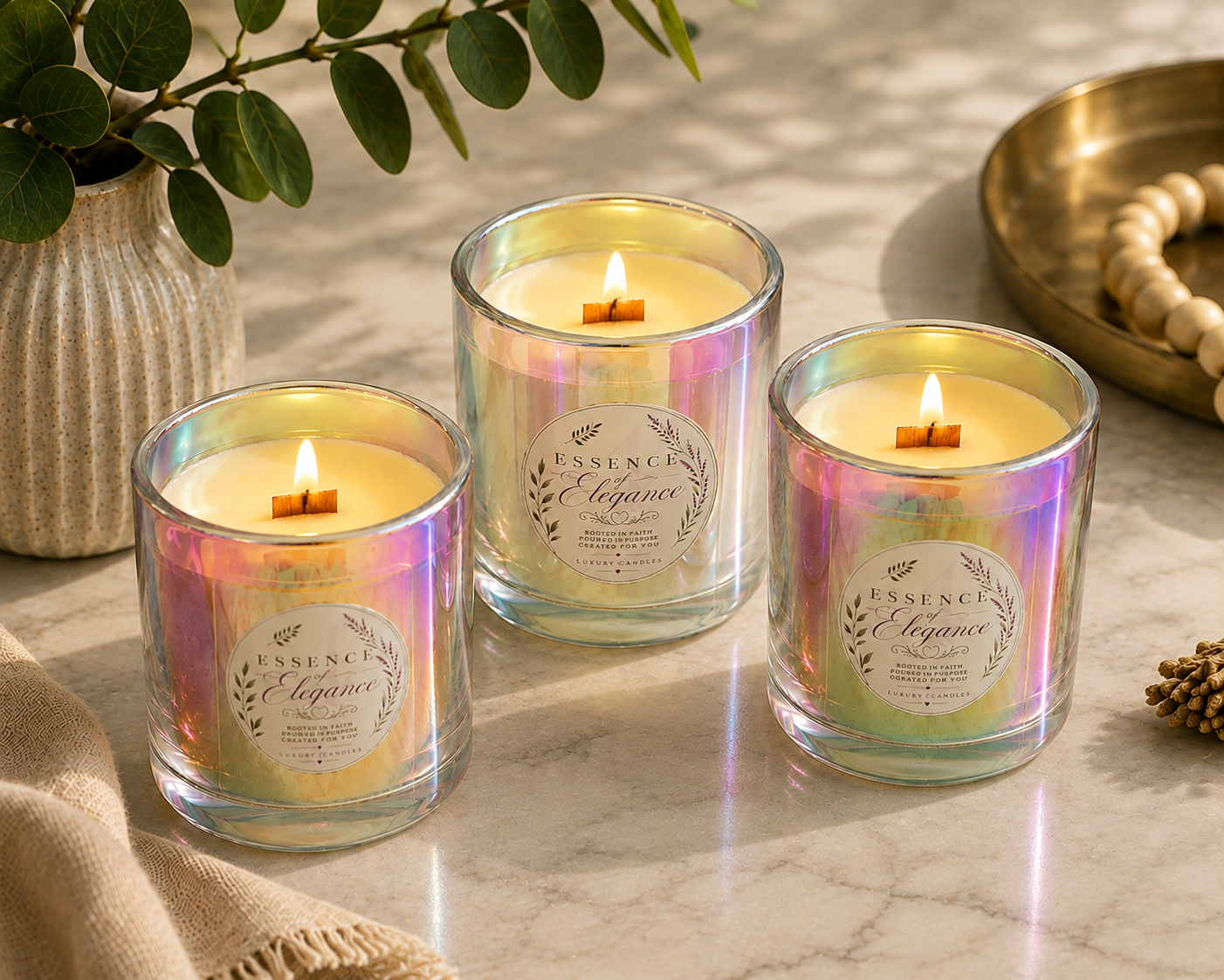 Three lit Essence of Elegance iridescent aura candles with wooden wicks on marble
